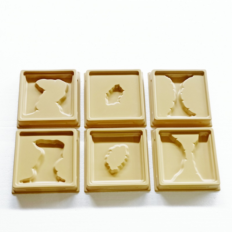 Vee ja maa pinnavormide õpetamiseks Montessori pedagoogikast tuntud kandikud.